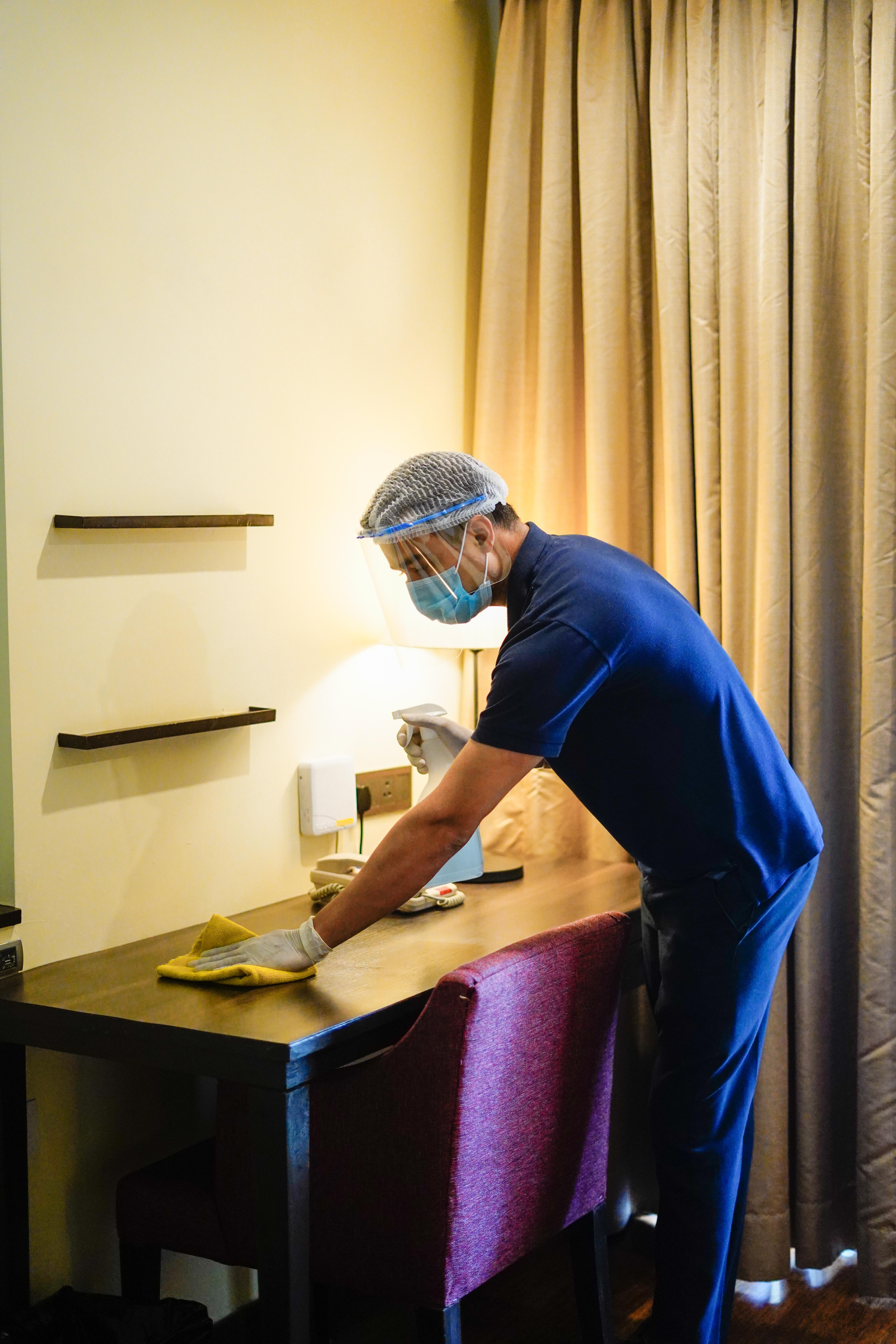 Novotel Goa Resort & Spa Candolim Zewnętrze zdjęcie A hotel housekeeper wearing a face shield and gloves